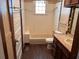 Bright bathroom featuring a tub-shower combo with tiled walls and a window for natural light at 389 Dargan Sw Pl, Atlanta, GA 30310