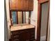 Bathroom vanity with oak cabinets and a tile countertop with mirror and custom vanity lighting at 389 Dargan Sw Pl, Atlanta, GA 30310