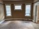 Neutral bedroom featuring light-filled windows and carpeted floor, offering a comfortable retreat at 389 Dargan Sw Pl, Atlanta, GA 30310
