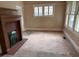A cozy living room with a fireplace and large windows, creating a warm and inviting space at 389 Dargan Sw Pl, Atlanta, GA 30310