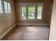 Bright living room featuring large windows providing ample natural light and carpeted flooring at 389 Dargan Sw Pl, Atlanta, GA 30310