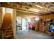 Unfinished basement with exposed rafters, wood stairs, and concrete flooring offering expansion potential at 4535 Sunflower Cir, Cumming, GA 30040