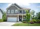 Attractive two-story home showcasing stone and siding, covered porch and colorful landscaping at 4535 Sunflower Cir, Cumming, GA 30040