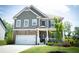 Beautiful two-story home with stone accents, inviting front porch, and a well-maintained lawn with lush landscaping at 4535 Sunflower Cir, Cumming, GA 30040