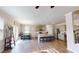 Open kitchen features stainless appliances, granite counters, island with seating, and hardwood floors at 4535 Sunflower Cir, Cumming, GA 30040
