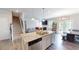 Spacious kitchen with a granite island and an open view to the living room at 4535 Sunflower Cir, Cumming, GA 30040