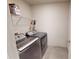 Laundry room with a washer and dryer under a rack with supplies at 4535 Sunflower Cir, Cumming, GA 30040