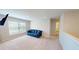Inviting living room with a comfortable blue sofa and natural light from a window at 4535 Sunflower Cir, Cumming, GA 30040