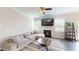 Bright living room showcases a fireplace, large windows, hardwood floors, and a neutral paint scheme at 4535 Sunflower Cir, Cumming, GA 30040