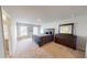 Spacious main bedroom with a modern bed and wooden dresser with mirror at 4535 Sunflower Cir, Cumming, GA 30040