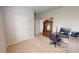 Carpeted office space with a desk, shelves, a hutch, and a window for natural lighting at 4535 Sunflower Cir, Cumming, GA 30040