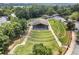 Aerial view of an outdoor amphitheater with terraced seating and a covered stage area at 3260 Kingshouse Commons, Johns Creek, GA 30022