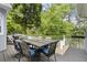 Back deck with outdoor seating area and view of lush greenery at 3260 Kingshouse Commons, Johns Creek, GA 30022