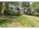 A large backyard with a lush lawn, stepping stones, and a multi-level deck for outdoor enjoyment at 3260 Kingshouse Commons, Johns Creek, GA 30022