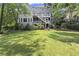 Expansive backyard featuring a lush lawn, a multi-level deck, and mature trees creating a serene outdoor space at 3260 Kingshouse Commons, Johns Creek, GA 30022
