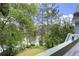 Back deck view of the water surrounded by green trees at 3260 Kingshouse Commons, Johns Creek, GA 30022