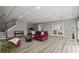 Spacious basement area with a red sofa, stairs, and outdoor access at 3260 Kingshouse Commons, Johns Creek, GA 30022
