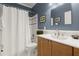 Bathroom featuring blue walls, a shower with white curtain, and classic fixtures at 3260 Kingshouse Commons, Johns Creek, GA 30022