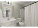 Bathroom with a white vanity, toilet, and a shower with a white curtain at 3260 Kingshouse Commons, Johns Creek, GA 30022
