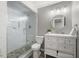 Updated bathroom featuring glass shower, white vanity, round mirror, and modern light fixture at 3260 Kingshouse Commons, Johns Creek, GA 30022