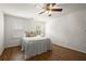 Bedroom with a bed, two windows, and hardwood floors; ample natural light at 3260 Kingshouse Commons, Johns Creek, GA 30022