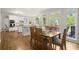 Open-concept dining room with kitchen view, hardwood floors, and bright natural light at 3260 Kingshouse Commons, Johns Creek, GA 30022