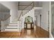 Grand foyer with hardwood floors, staircase, and elegant decor, creating a welcoming entrance at 3260 Kingshouse Commons, Johns Creek, GA 30022