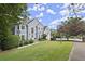 Charming two-story home with a well-manicured lawn, mature landscaping, and a welcoming facade at 3260 Kingshouse Commons, Johns Creek, GA 30022