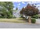 Elegant home with a manicured front lawn, arched entryway, and mature landscaping, offering great curb appeal at 3260 Kingshouse Commons, Johns Creek, GA 30022
