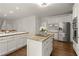 Spacious kitchen with stainless appliances, center island with granite countertops and white cabinets at 3260 Kingshouse Commons, Johns Creek, GA 30022