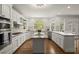 Spacious kitchen with white cabinetry, stainless steel appliances, and a large center island at 3260 Kingshouse Commons, Johns Creek, GA 30022