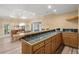 A bright and functional kitchen area with wood cabinetry, tiled countertop and modern appliances at 3260 Kingshouse Commons, Johns Creek, GA 30022