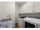 Convenient laundry room with ample storage and modern washer and dryer units at 3260 Kingshouse Commons, Johns Creek, GA 30022