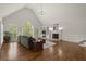 Bright living room featuring hardwood floors, vaulted ceilings, fireplace and large windows at 3260 Kingshouse Commons, Johns Creek, GA 30022