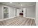 Living room with hardwood floors, ample natural light, and an open doorway at 3260 Kingshouse Commons, Johns Creek, GA 30022
