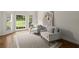 Bright living room featuring armchairs, neutral rug, and natural light from windows at 3260 Kingshouse Commons, Johns Creek, GA 30022