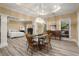 Open-concept living room with a dining area, wood floors, and large windows providing plenty of natural light at 3260 Kingshouse Commons, Johns Creek, GA 30022
