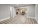 View of a living room with hardwood floors leading to the breakfast area at 3260 Kingshouse Commons, Johns Creek, GA 30022
