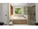 Luxurious main bathroom with soaking tub, a large window, and a separate tiled shower at 3260 Kingshouse Commons, Johns Creek, GA 30022