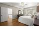 Spacious main bedroom with hardwood floors, bay window, and access to the main bath at 3260 Kingshouse Commons, Johns Creek, GA 30022