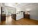 Serene main bedroom featuring a bay window, hardwood floors, and tray ceiling at 3260 Kingshouse Commons, Johns Creek, GA 30022