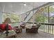 Relaxing screened-in porch with comfortable seating and scenic views of the backyard at 3260 Kingshouse Commons, Johns Creek, GA 30022