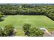 An aerial shot of a soccer field with well-maintained grass and trees at 3260 Kingshouse Commons, Johns Creek, GA 30022