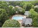 Aerial shot of a large community swimming pool with plenty of lounge chairs and a building at 3260 Kingshouse Commons, Johns Creek, GA 30022