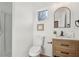 This cozy bathroom features a toilet, a vanity with a framed mirror, and a walk-in shower at 3939 Hamilton Mill Rd, Buford, GA 30519