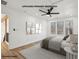 This primary bedroom features three windows, a ceiling fan, and a neutral color palette for relaxation at 3939 Hamilton Mill Rd, Buford, GA 30519