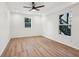 Bright bedroom with wood floors, recessed lighting, ceiling fan, and two large windows at 3939 Hamilton Mill Rd, Buford, GA 30519