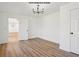 Bright office/bonus room featuring hardwood floors and a modern chandelier at 3939 Hamilton Mill Rd, Buford, GA 30519