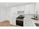 Bright kitchen boasts stainless steel appliances, white cabinets, and light countertops at 3939 Hamilton Mill Rd, Buford, GA 30519