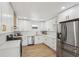 Bright kitchen with white cabinets, stainless steel appliances, quartz countertops, and hardwood floors at 3939 Hamilton Mill Rd, Buford, GA 30519